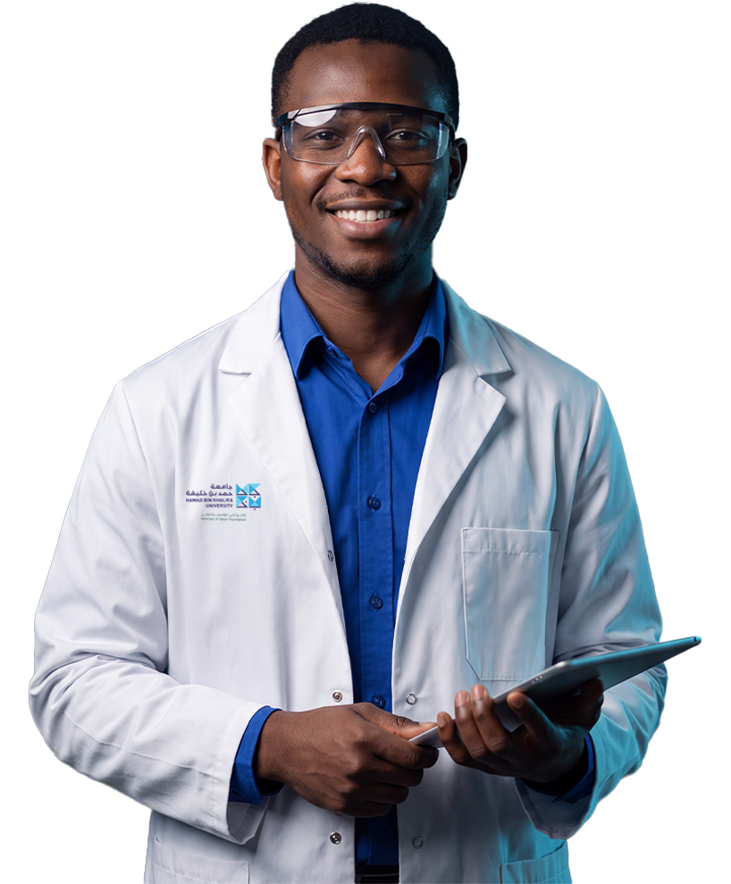 HBKU student in a branded white lab coat and safety goggles holding a tablet